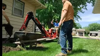 Harbor freight backhoe, digging out an egress window and 2 stumps!