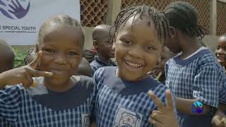 Nigerian children receive back to school educational materials from donors.