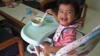 1 Year old Baby learning to eat with spoon