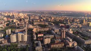 Panoramic aerial view of the big city on the river. City landscape. Wonderful sunset view.