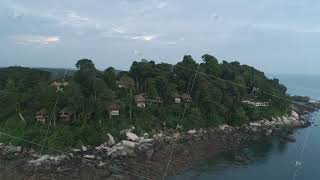 Aerial view along coastline of beautiful island. Shot. Green island with pine trees shores and