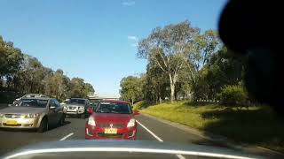 flick.com.au 2013 Toyota Hiace van driving in the M5 motorway shoulder.