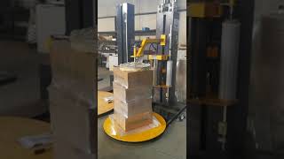 Automatic pallet wrapper with top press