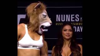 Amanda Nunes in Lioness Mask facing off against Ronda Rousey