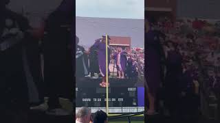 Girl dances on stage at graduation and go back to tell the announcer that he pronounced he