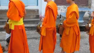 Luang Prabang, Laos - Buddhist monks collecting morning alms continued