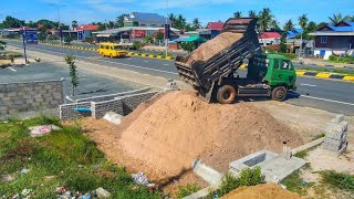 Clearing weed and burying drainage system in front of the house next to the motorway.