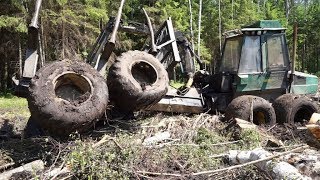 Fully loaded Timberjack 1210 stuck in mud