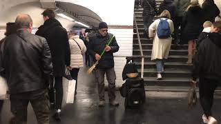 Inside Paris Metro, a gentleman is begging to be song and a beautiful song is served.