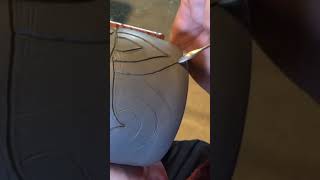 Carving a clay pot