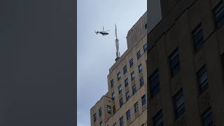 NYPD heli-ops helicopter near Empire State Building NYC New York City FDNY