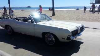 Vintage cars cruise the beach in Oceanside.