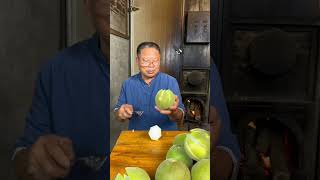 The craftsman is collecting the peel of a citrus fruit, which can be used as a medicinal herb.