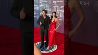 Charlie Puth poses with fiancé Brooke Sansone at the BreakthroughPrize red carpet