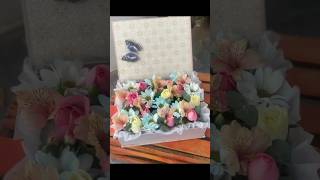 Floral foam arrangement with mixed flowers in a box