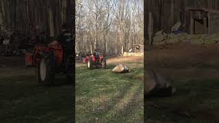 Tractor drags boulder across lawn