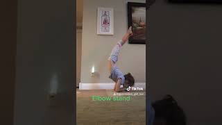 Seven year old doing elbow stand