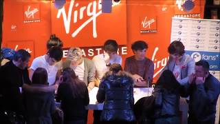 Louis and Harry dancing at a signing