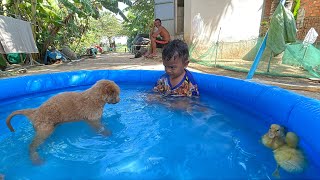 Funny Video with cute boy bathing and playing with a duckling without knowing the puppy behind it.