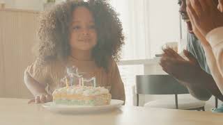 Joyous Celebration: Man and Woman Celebrating Girl's Birthday - Free 4K Stock Footage Download