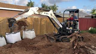 Alex and Doug using an excavator