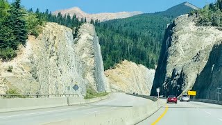 DRIVING THROUGH THE WILDERNESS ADMIRING THE MOUNTAIN VIEW