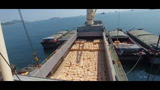 derrick crane operation at Koh Sichang thailand  anchorage loading rice