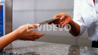 Female airport staff giving passport to woman at check in desk