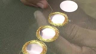 stitching of mirrors on net fabric