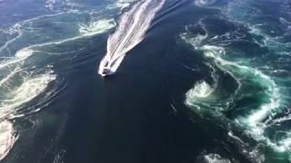 Boat cruising through Saltstraumen maelstrom near Bodø Norway