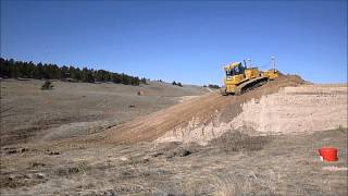 Deere 850J LGP Pushing Up Some Slopes