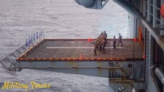 U.S. marines conduct a machine gun shoot aboard the amphibious assault ship USS America