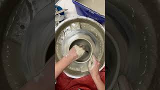 Throwing a wide rimmed bowl on the pottery wheel in white stoneware.