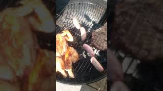 Cooking up the brined chicken bird couple sausages and the ribeye steak on the charcoal Weber 22"!