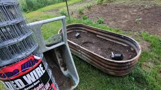 KUBOTA L2501, KUBOTA RTV 900, and TWO JOHN DEERE 520'S MAKING A RACCOON PROOF GARDEN FENCE