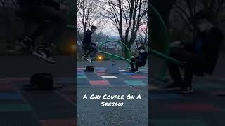 A Gay Couple On A Seesaw