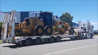 Caterpillar 140M Grader Departure from Depot on Kenworth Quad Float