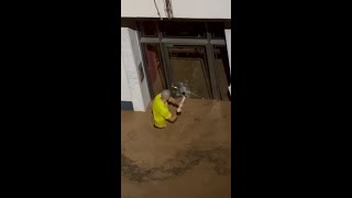 Man smashes glass door to save children in Spanish floods