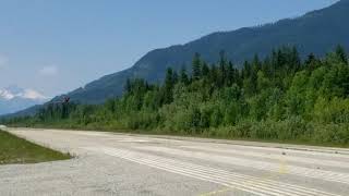 Lancair Legacy flying down Nakusp runway