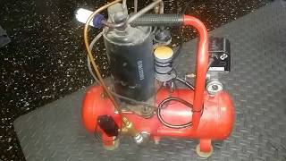 Silent air compressor with a solenoid pressure relief valve