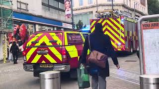 Fire brigade in Leeds show moving with blue lights driving onto headrow.