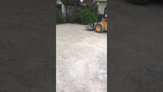 Asphalt Driveway installation:Preparing road base, compacting, rolling, and then asphalt laid.