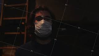 Portrait of a young man wearing protective medical mask in front of wooden ladder and the screen