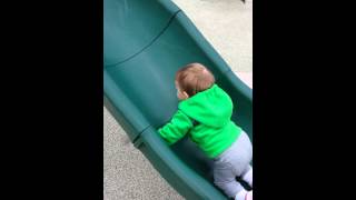 Baby niece tries  to climb UP the slide