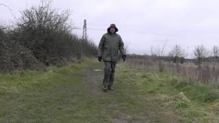 Green rainsuit and black rubber boots in the countryside