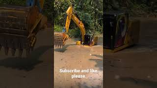 Excavator driving in river