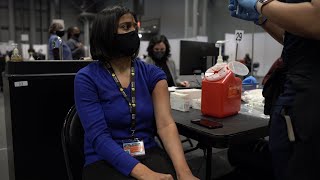 Staff workers at the Javits NY vaccination site receive the vaccine