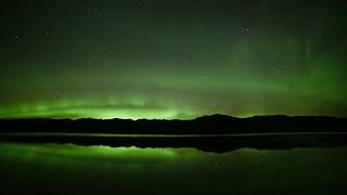 A MAGNIFICENT display of Northern Lights Aurora Borealis over YUKON RIVER, CANADA