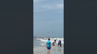 Military black hawk flying over coco beach