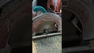 cutting wood with electric saw Makita.